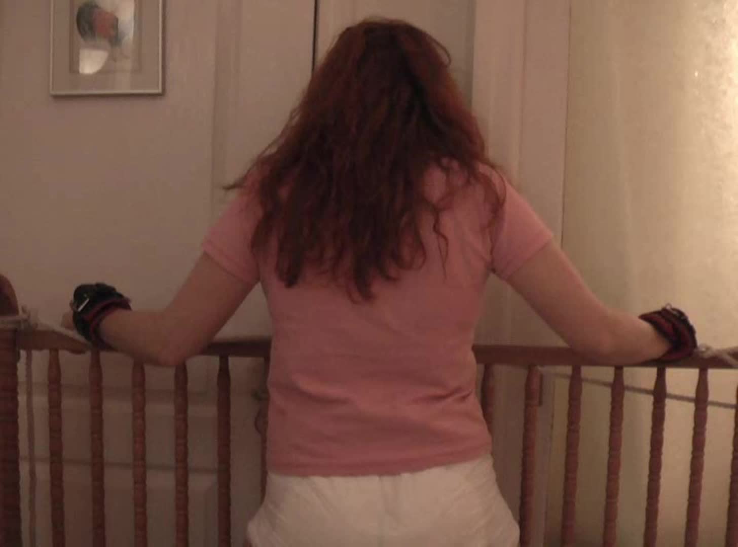 Tied up and diapered tight on the crib rail